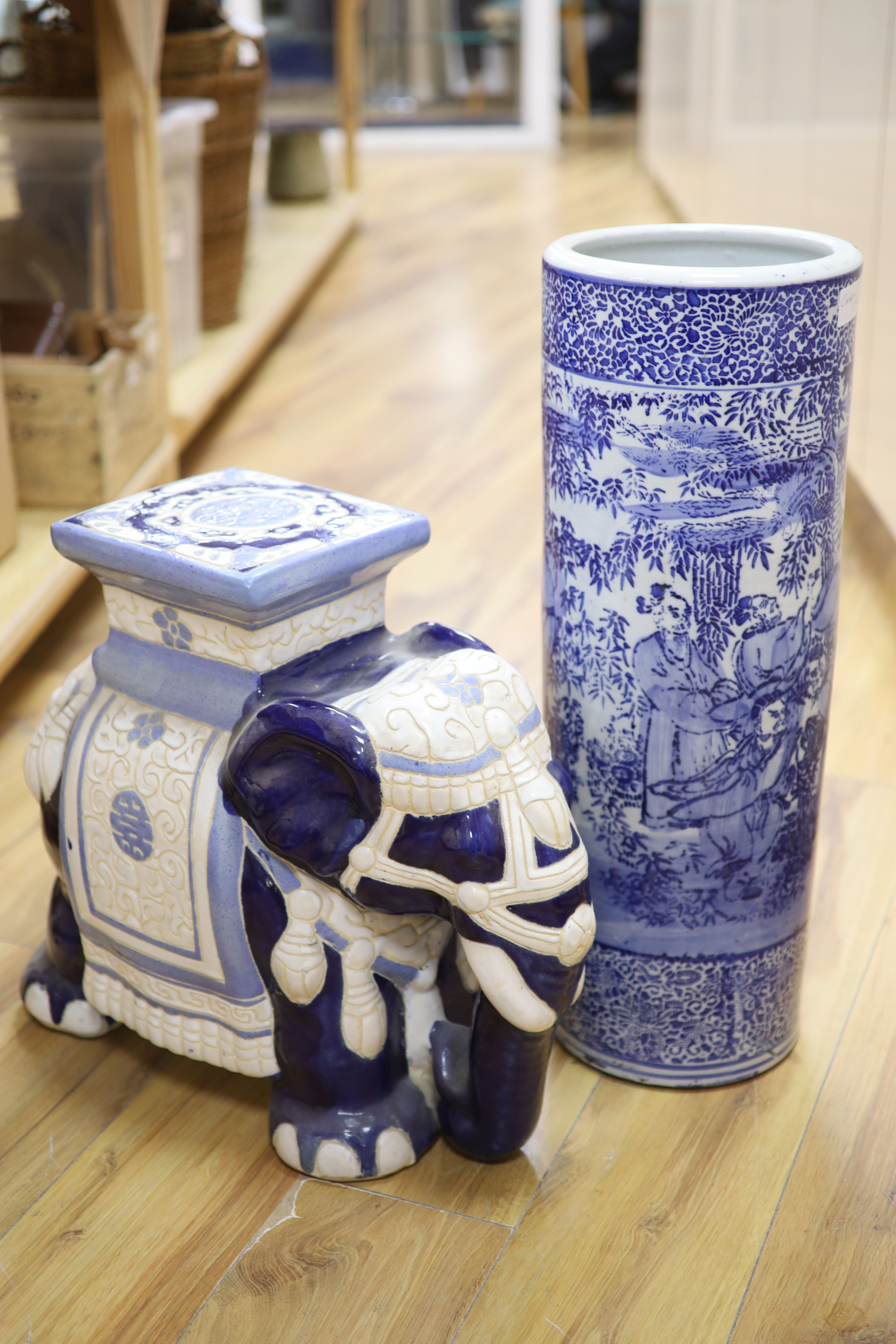 Two Chinese ceramic elephant garden seats and a blue and white stick stand, height 61cm